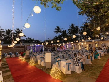 A arranged wedding reception featuring white and blue tables & chairs, creating a festive atmosphere.